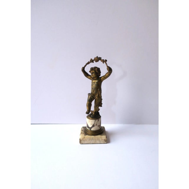 An antique French gold gilt bronze male 'putti' figure sculpture atop a marble column, Belle Epoque, circa late-19th...