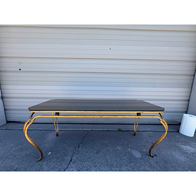 French Gilt Iron And Mirrored Cocktail Table. Offered is a glamorous French mid-century hand wrought gilt iron rectangular...