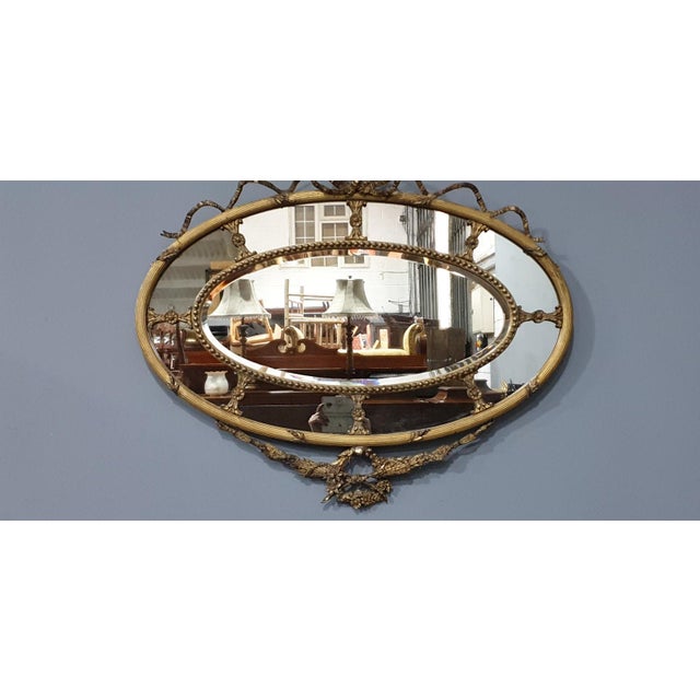A very nice English Regency marginal mirror with ribbon detailing, central bevelled mirror, in very good order throughout....