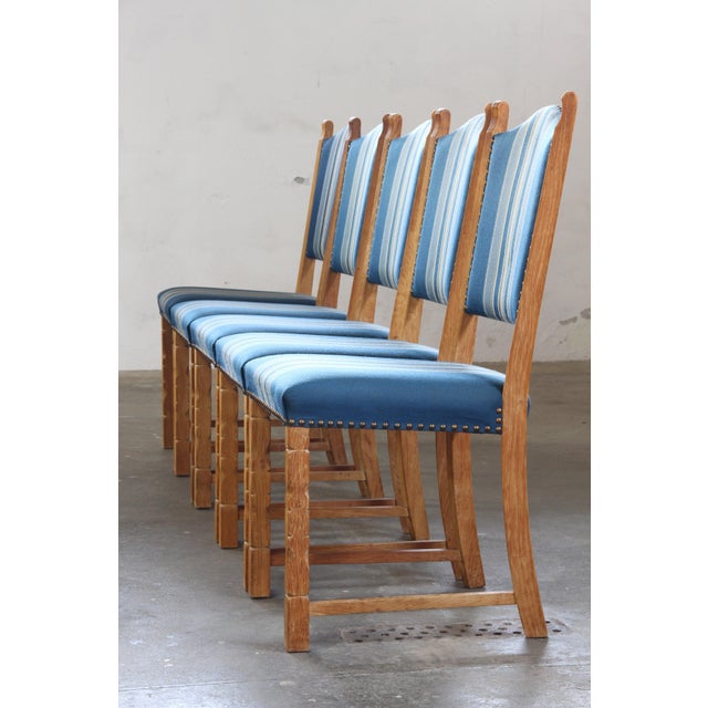 Presenting these delightful five Danish oak dining chairs attributed to Henning Kjærnulf, a set that perfectly captures...
