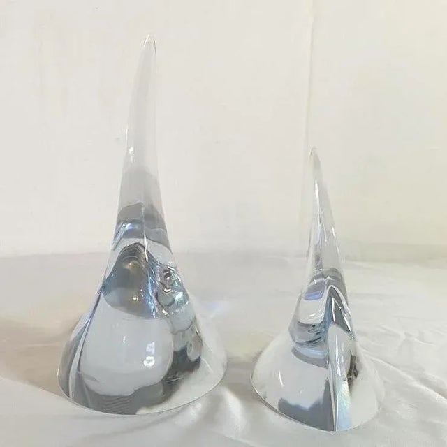 Amazing paperweights made by SKLO. Abstract shape is replicated in this pair. Larger one measures 8.5”l, 4.5”w, 8.5”h...