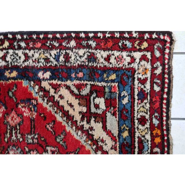 Handmade vintage Persian Malayer rug in red color. The rug has been made in wool in the middle of 20th century. It is in...