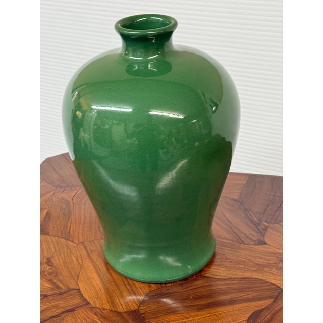 Design Plus Gallery presents an Antique Replica Chinese Meiping Vase. This porcelain vessel showcases a vibrant green...