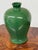 Design Plus Gallery presents an Antique Replica Chinese Meiping Vase. This porcelain vessel showcases a vibrant green...