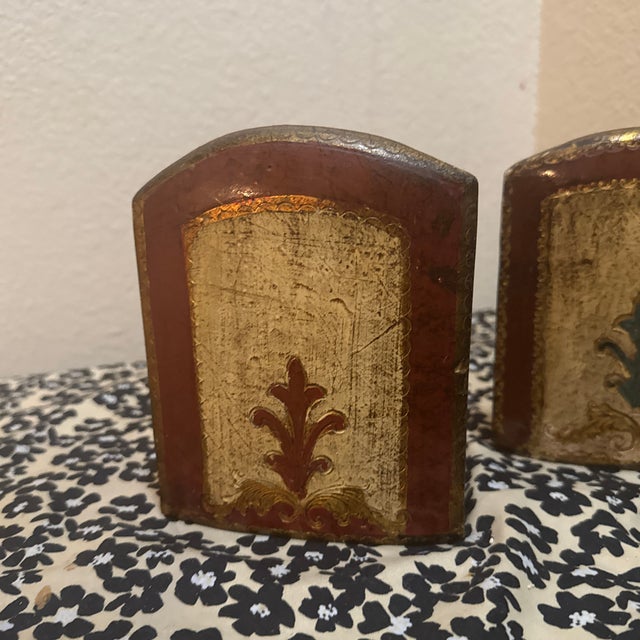 A charming pair of vintage Italian Florentine bookends, featuring a classic gold-gilt and hand-painted finish. These...