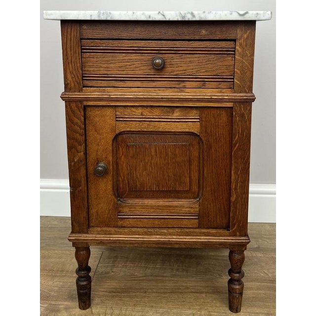 Bring timeless French character into your home with this elegant Antique French oak bedside cupboard featuring a beautiful...