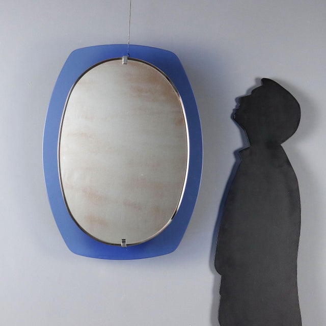 This 1960s Italian-made wall mirror features a distinctive design reflecting the style of the period. The reflective...