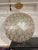Design Plus Gallery presents a Capiz Honeycomb Pendant Light by Serena & Lily. This pendant has a rounded globe form...