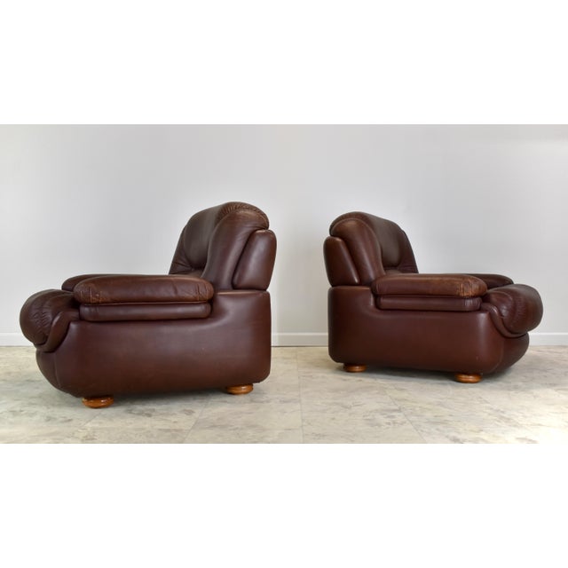 A pair of 1970's era post modern leather lounge chairs in the style of Mario Marenco. Compact and plush these chairs...