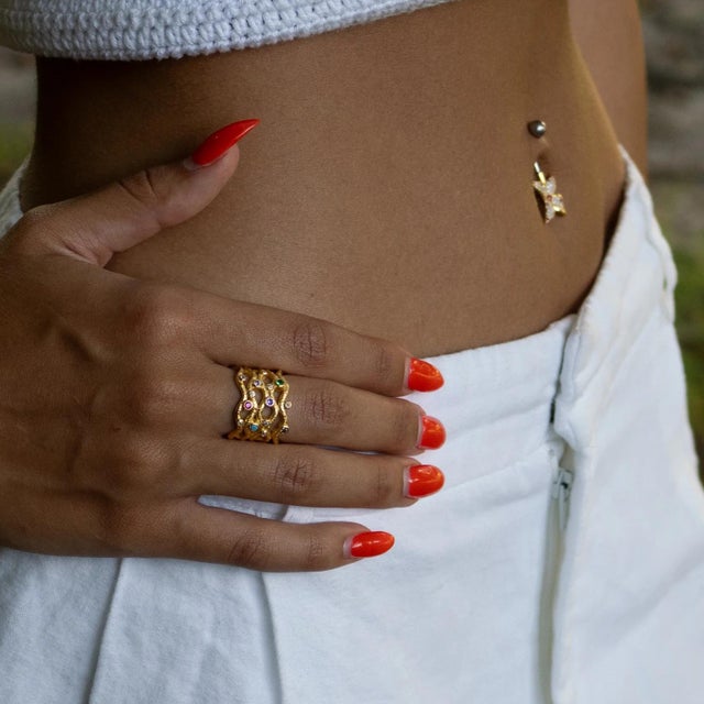 Embrace timeless elegance with the Eternal Waves Multi Gemstone Gold Statement Ring, a bold design that captures the...