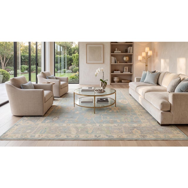 Elevate your space with this hand-knotted modern Oushak style wool rug, featuring a tranquil palette of soft duck egg...