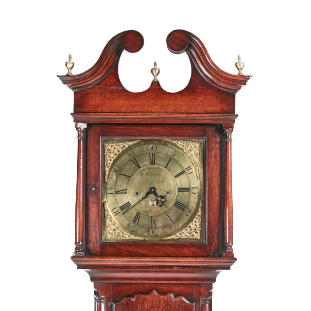 This is a magnificent example of a George II brass face red walnut longcase clock. The hood having and elegant broken...