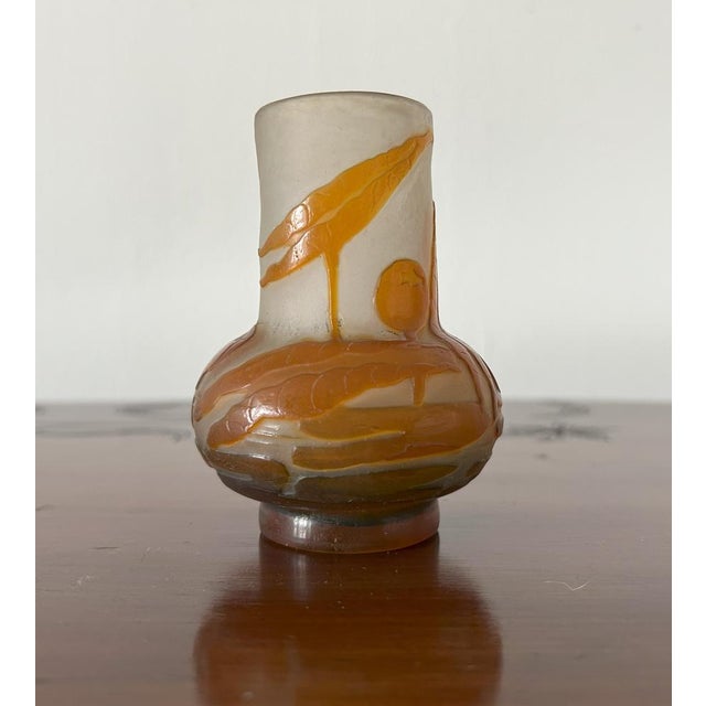 Émile Gallé (1846 - 1904) Small glass vase with color-layered cameo work. Phytomorphic decoration, depicting leaves and...