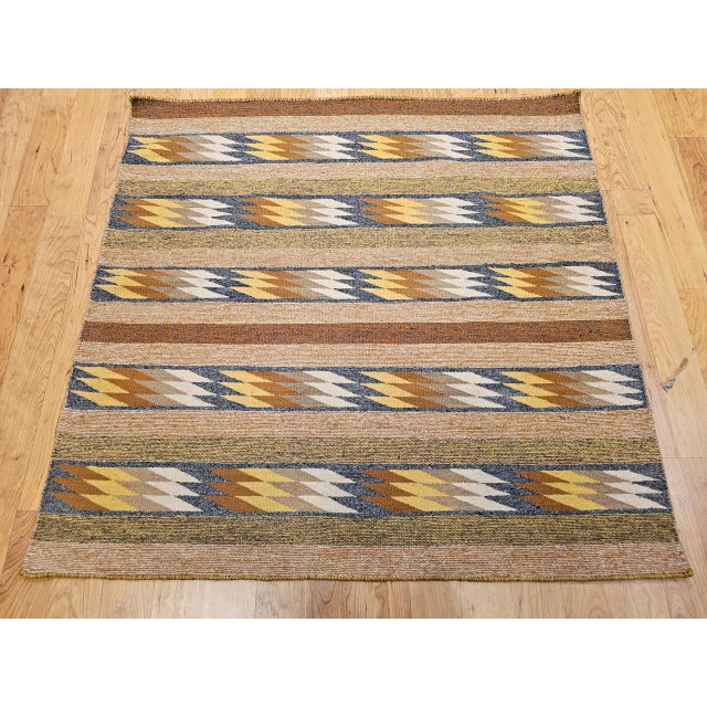 An exceptionally rare square-format Navajo rug, handwoven in the Southwestern United States during the third quarter of...