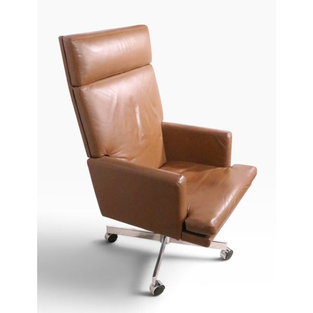 Chic vintage high back swivel desk chair, in brown leather, mounted on a chrome four star base, with original wheel caster...