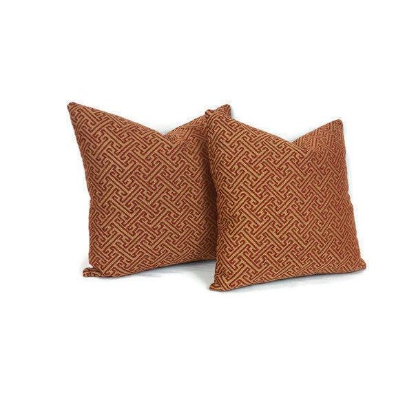 From Kravet Smart is a red and gold fretwork pattern pillow cover. The gold catches the light and brings out a shine that...