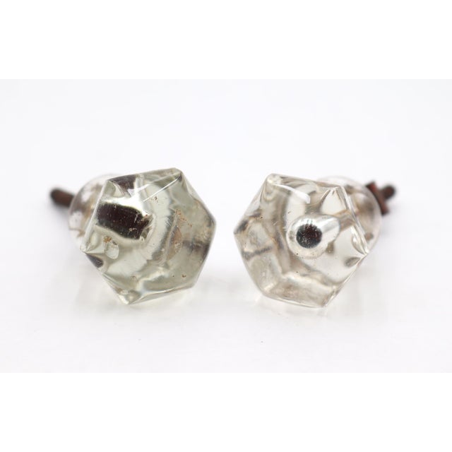Vintage cabinet or drawer knobs made of clear glass with a hexagon shape and a bullet center. One mounting nut is not...