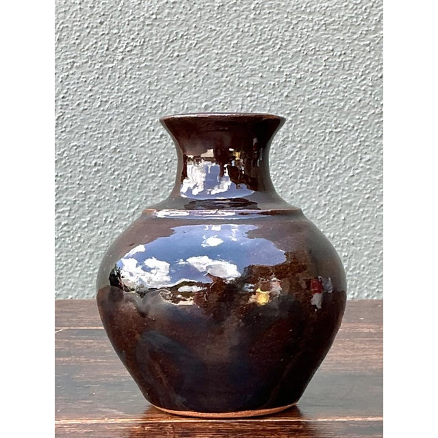 This signed ceramic vase by Solomon is a beautifully crafted example of vintage studio pottery, distinguished by its...