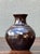 This signed ceramic vase by Solomon is a beautifully crafted example of vintage studio pottery, distinguished by its...