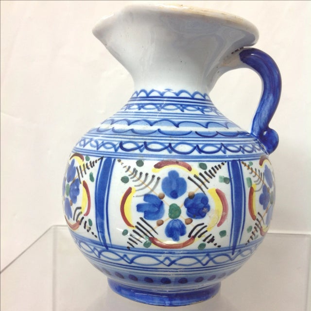 Hand-painted Puebla Talavera 5-color pitcher from 1937. Its color palette includes blue, red, yellow, green, and black......
