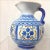 Hand-painted Puebla Talavera 5-color pitcher from 1937. Its color palette includes blue, red, yellow, green, and black......