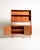 Teak bookcase with adjustable shelves, a pull-out writing surface, three small upper drawers, and a lower storage unit....