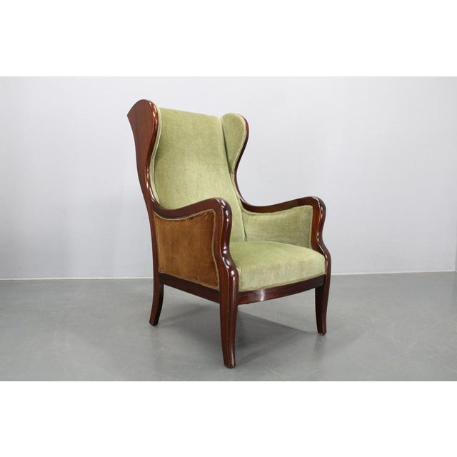 This exceptional Danish mid-century wingback armchair was designed by Frits Henningsen and produced in Denmark during the...