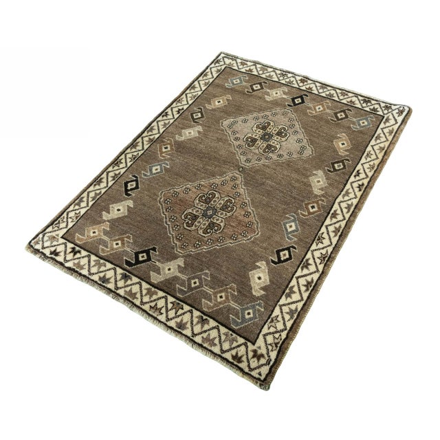 An authentic Gabbeh nomadic rug with a timeless appeal. The geometric center pattern with stylized shapes and symbolic...