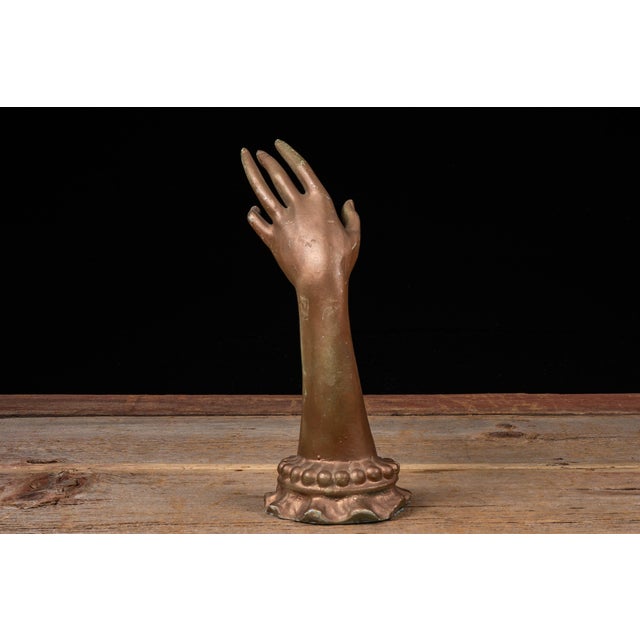Mid-century jewelry display hand modeled with an elongated wrist and gracefully extended fingers for presenting rings,...
