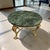 Make a dramatic statement with this elegant Hollywood Regency round center table, featuring a richly veined green marble...
