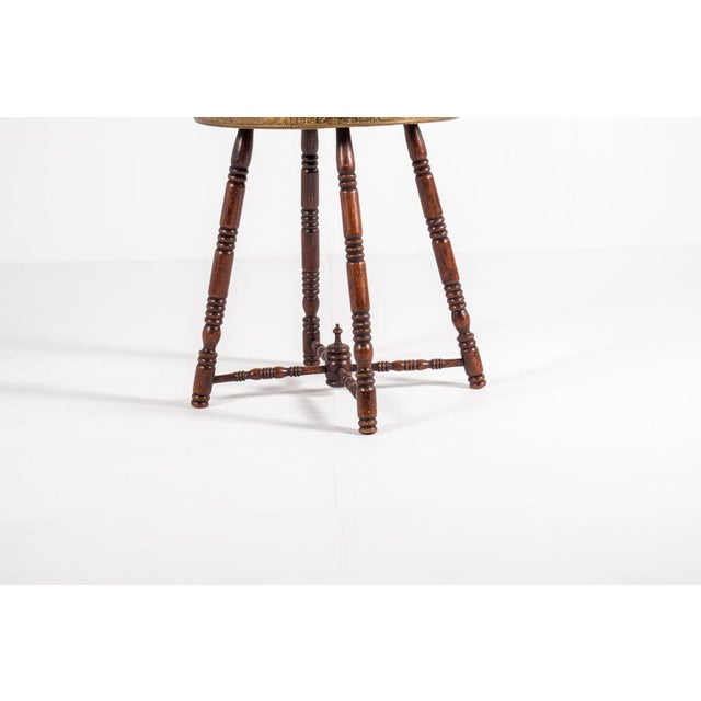 This unique antique side table features a beautifully embossed brass tray top with intricate Oriental-inspired patterns....