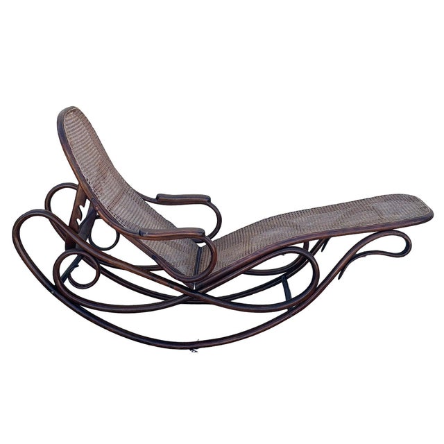 Victorian bent oak & cane number 7500 chaise lounge chair by Gebrüder Thonet features an elegant, sculptural frame crafted...