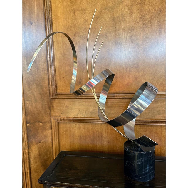 A vintage tabletop sculpture crafted by C. Jere and dated to 1978. The metal sculpture was constructed from chromed steel...