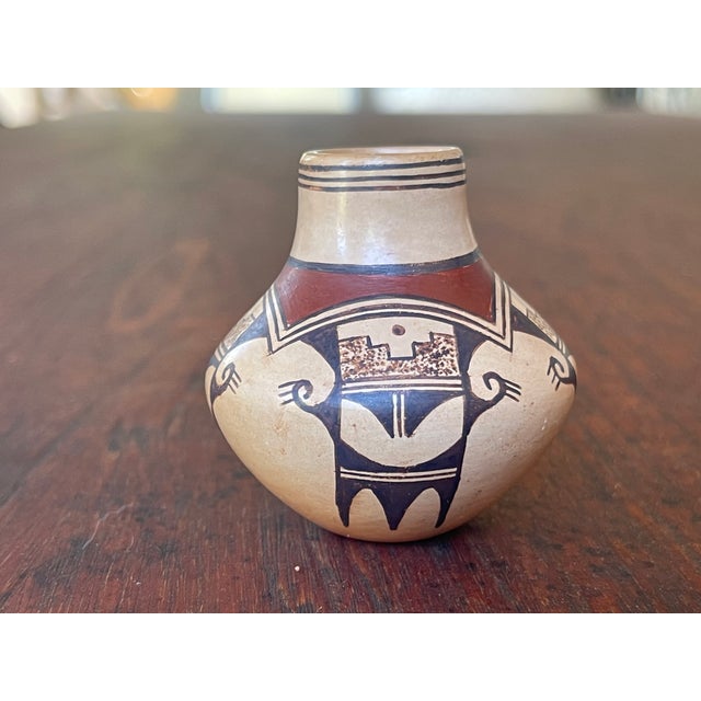 This is a hand-coiled Hopi-Tewa polychrome miniature pot created by a member of the famous Nampeyo family of potters from...