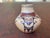 This is a hand-coiled Hopi-Tewa polychrome miniature pot created by a member of the famous Nampeyo family of potters from...