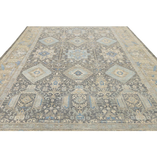 Enhance your space with this Modern Tabriz style area rug, expertly hand-knotted from premium wool and genuine silk. In a...