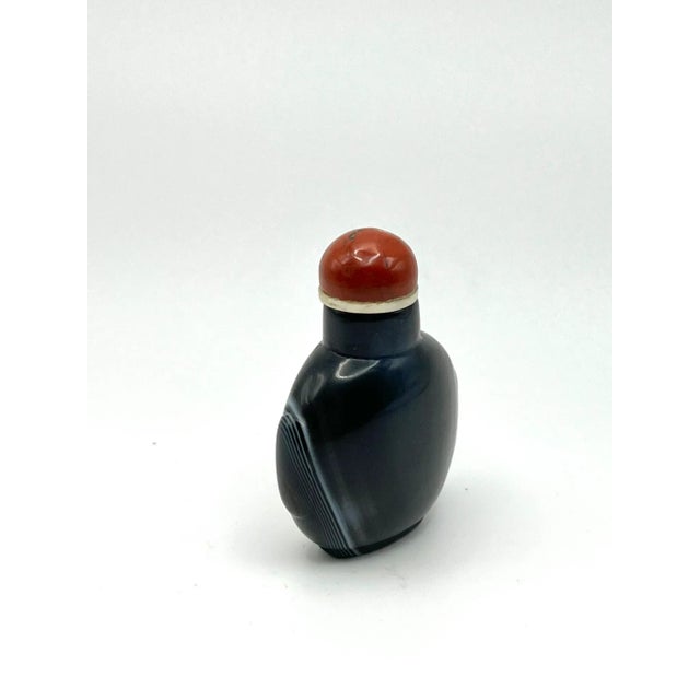 This is an unique black agate bottle. The carver was very ingenious to select a rock in the right proportions to be a...