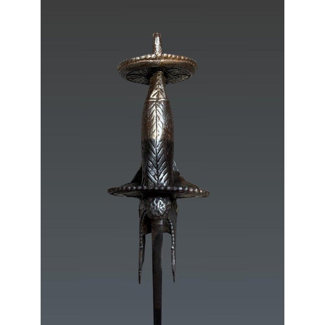 Firangi type saber with khanda handle India, 17th century A long European Damascus steel blade, slightly curved, with a...