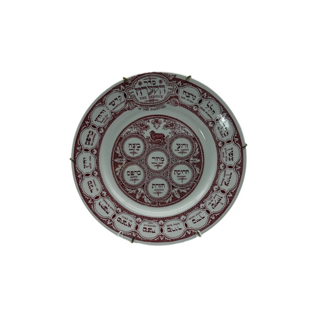 A beautiful early 20th-century English Judaica piece by Ridgway featuring The Service of the Passover in rich burgundy...