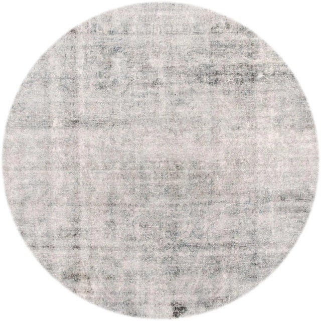 A hand-knotted antique Persian Kerman rug with an all-over design. This rug measures 10'3" x 17'9".