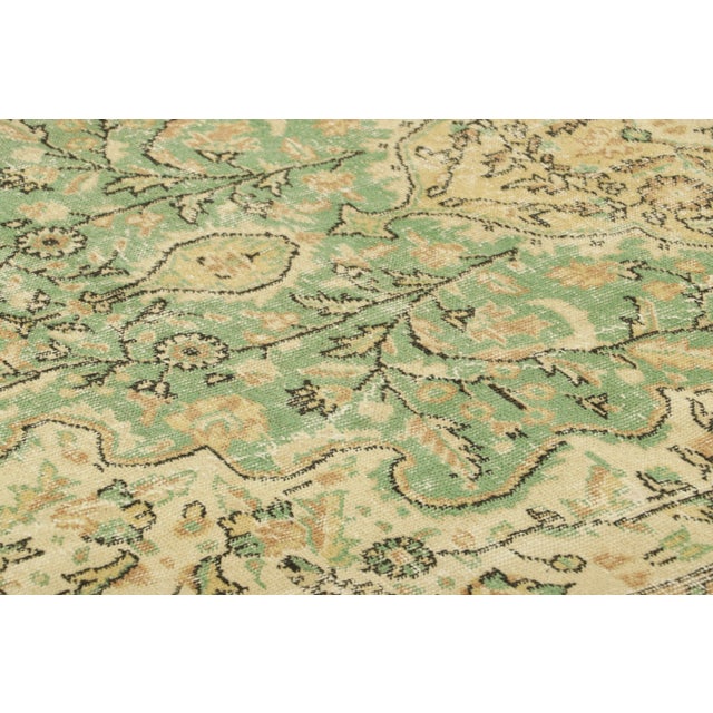 Made with hand-knotted wool in Turkey circa 1950-1960, this 5x9 vintage rug is an exciting new mid-century curation from...