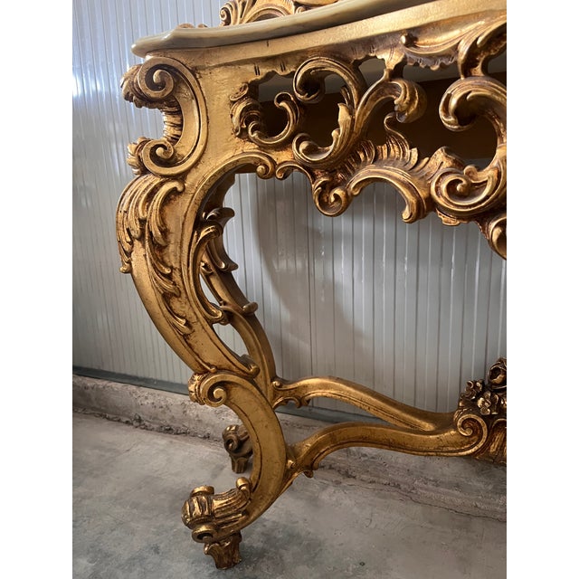 20th-century Italian Baroque console table with mirror with beige marble top Fully carved and in good condition Well-...