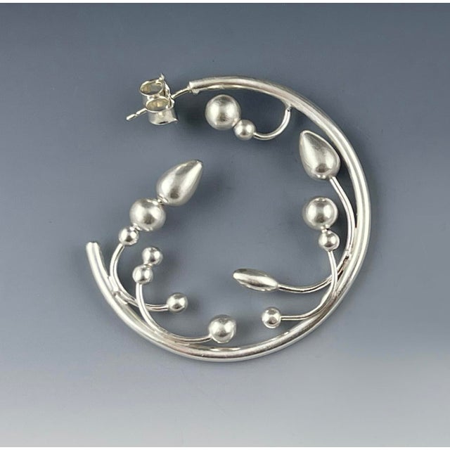 These hand-fabricated sterling silver hoops have sweet little buds and sprouts, perfect for a day in the garden! Handmade...