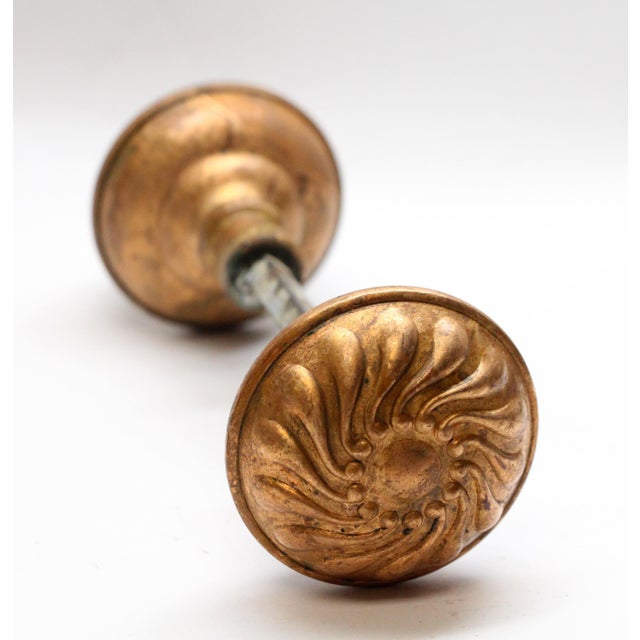 This Vernacular style bronze pinwheel entry door knobs were made by Corbin in 1895. It is part of the E-10200 group. This...