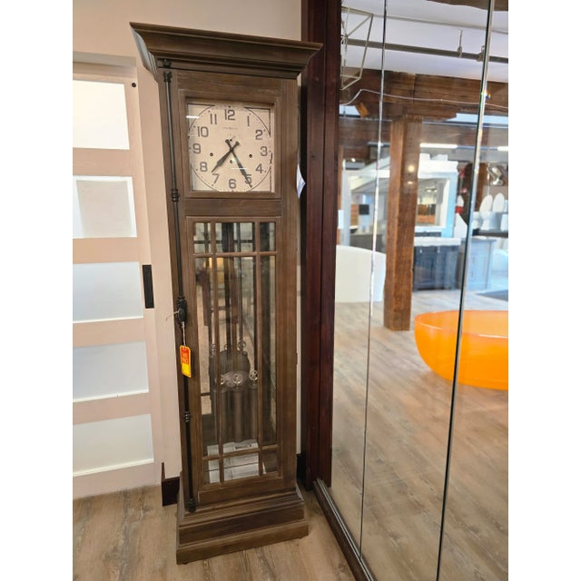 The Davidson Floor Clock has an aged Auburn finish on select hardwoods and veneers, distressed with dents and wire brushed...