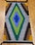 This striking vintage American Navajo rug, woven in the mid-20th century in the Southwestern United States, is a vivid...