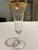 Four very pretty fluted champagne glasses with decorative gold band at top and gold rimmed feet.