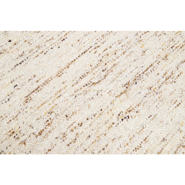 Beautiful modern Moroccan-style hand-knotted wool rug with a beige color field. This Apadana's Safi Collection rug has...