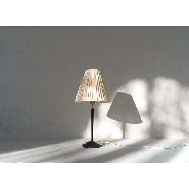 A great looking table lamp made in Sweden at famous ASEA produced in the 1950s. This one with a fabric shade and the lamp...