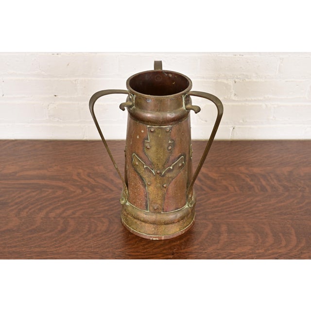 A gorgeous Arts & Crafts period Russian three-handled hammered copper and brass large vase or tankard with applied...